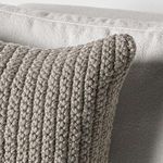 Close-up of pillow corner highlighting tightly knit stitch texture and plump filling