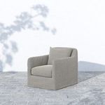 Dade Outdoor Swivel Chair on gray stone floor with soft shadow from surrounding outdoor lighting