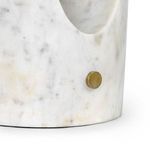 Close-up of marble base texture showing lavender and beige veining with round brass dimmer knob