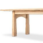 Table angled from a corner in a studio setting with visible arched leg bases