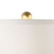 Detail of gold leaf finial on top of white silk drum shade