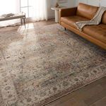 Starling Medallion Tan/Pink rug styled in living room with leather sofa, bench, and natural light