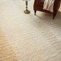 Close-up of Santa Fe Rug under side table and leather chair showing textured stripes