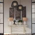 Two Osbert Black Pendants hanging in a decorated interior room with rustic art and lamps on wooden table