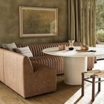 Banquette corner in room setting with natural light, paired with light-colored dining table