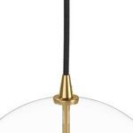 Close-up of brass pendant cap attaching black braided cord to clear glass globe