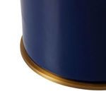 Close-up of the lamp base showing smooth midnight blue ceramic finish with a brushed brass ring at the bottom edge