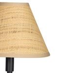 Close-up of woven natural rattan shade with beige trim on lamp