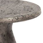 Side angle focusing on the rounded edge and curved base of the Collins Outdoor Accent Table