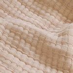 Detailed macro view of woven textured grid pattern on amber Vancouver Coverlet fabric
