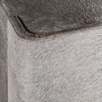 Close-up of upper cabinet edge showing hair-on-hide texture with rounded corner detail