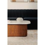 Side view of Dash coffee table in a living room with black sofa and art on walls