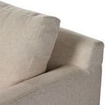 Close-up of slipcovered back cushion seam detail and track arm corner