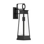 Matte black outdoor lantern shown from side, highlighting the wall mount bracket and circular top handle