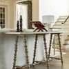 Kirkwood Console Table in living room setting with staircase and wall paneling in background