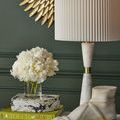 Close-up of brass midsection dividing two parts of white marble lamp body