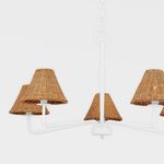 Top view of white metal chandelier center with five rattan shades under soft light