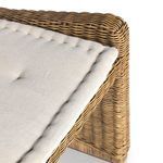 Partial close-up emphasizing thickness and texture of tufted seat cushion on rattan frame