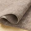 Louisa Taupe / Ivory rug edge rolled up, showing underside backing and soft velvety pile texture
