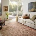 Anniston Clay Charcoal rug styled in a living room with sofa, chair, and natural light from window
