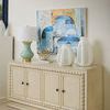 Thiri Lamp styled on a cream wood sideboard with white decorative vases and abstract wall art