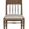 Front view highlighting carved spindles, welt trim on seat, and warm brown honey oak finish