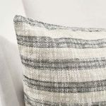 Detailed close-up of pillow’s textured fabric and stripe pattern on sofa corner