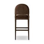 Rear view showing the rounded upholstered backrest and wood frame from behind