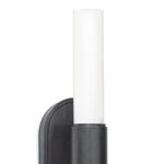 Close-up of top half of cylindrical frosted glass with black metal casing from angled view