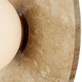 Close-up showing detailed grain and variations in beige travertine stone circle