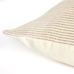 Detail of backside corner displaying plain beige fabric and woven striped front edge