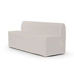 Three-quarter rear angle of Ainsworth bench emphasizing rounded backrest and clean slipcover drape.