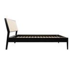 Side profile view highlighting angled cane headboard and flat wooden frame base