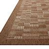 Low-angle side view highlighting the rug’s flat weave texture and rust color border