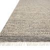Angled view of Omen Grey Rug focusing on fringed edge and dense weave detail