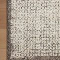 Close-up of corner edge on wood floor highlighting soft pile and color variation