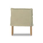 Back view of armchair highlighting smooth khaki linen slipcover with visible hem
