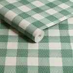 Close-up of rolled wallpaper showing texture and paint stroke details on green and white gingham pattern