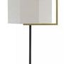 Close-up of the lamp showing the rectangular brass arm and finial detail atop the off-white shantung shade