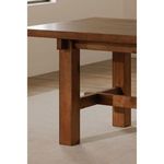 Side view of table leg on beige carpet with hardwood floor and white wall in background