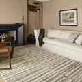 Humphrey rug displayed in a beige living room with a cream sofa and fireplace
