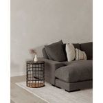 Dark grey Plunge sectional corner with decorative pillows and black wire side table in light room