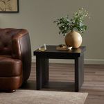 Warby End Table styled next to a brown leather chair with decor on top in a living room setting