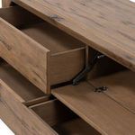 Close-up of open drawer hinges and interior storage compartments