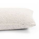 Pillow viewed from angled side highlighting zipper detail and textured fabric