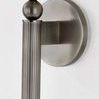 Close-up of the fluted metal body and stacked decorative spheres of Lakeport Wall Sconce with brushed finish