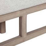 Detail of wooden support beams beneath seat cushion with natural wood grain