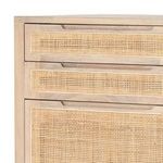 Close-up of cane drawer fronts with subtle wood frame joinery details