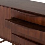 Close-up on curved handles of the four central drawers with one drawer open, revealing the wood interior