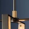 Edgemere Pendant with geometric architectural silhouette featuring LED strips integrated into an open metal cage with alab...